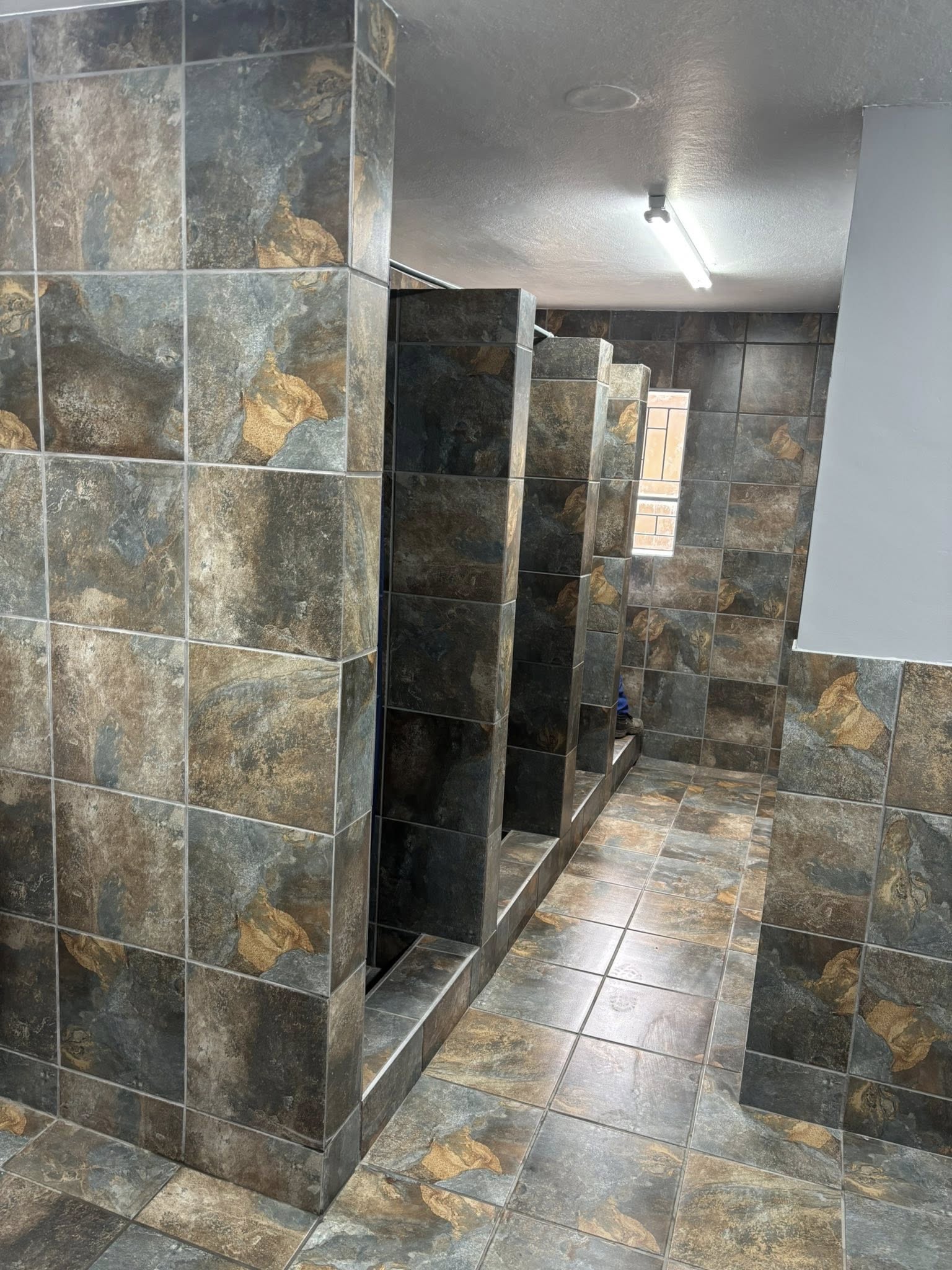 Commercial bathroom renovation with tiling and sanitaryware