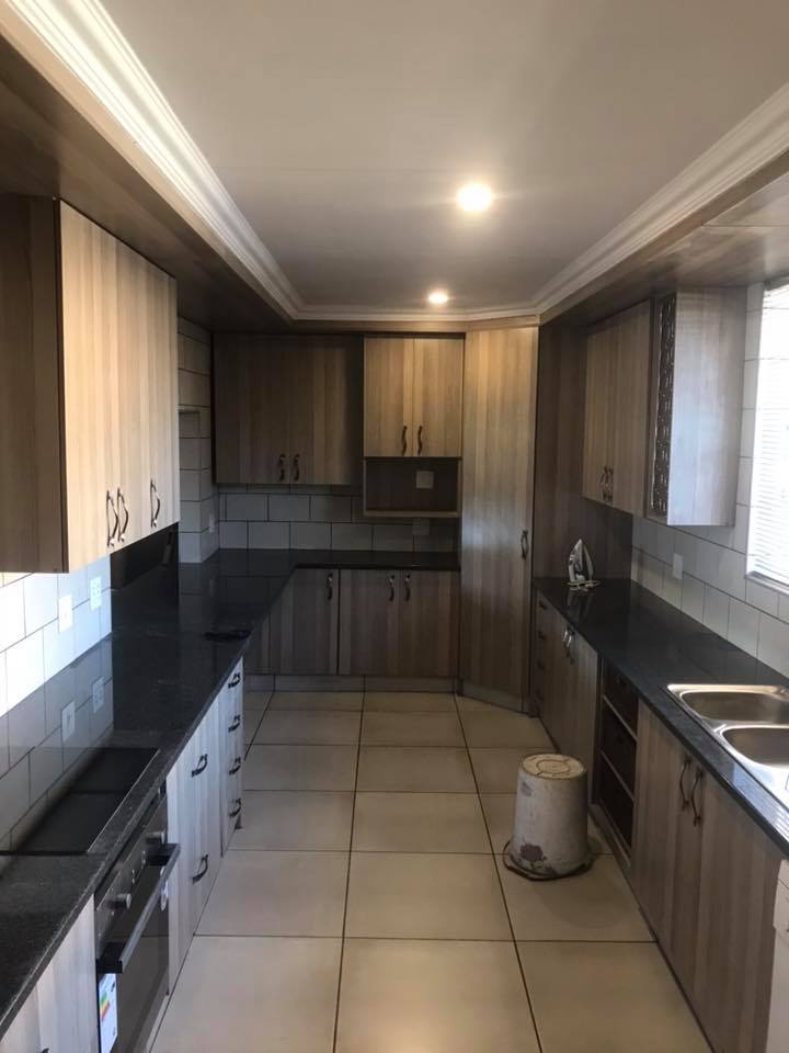 Modern kitchen renovation with custom cabinetry and tiling